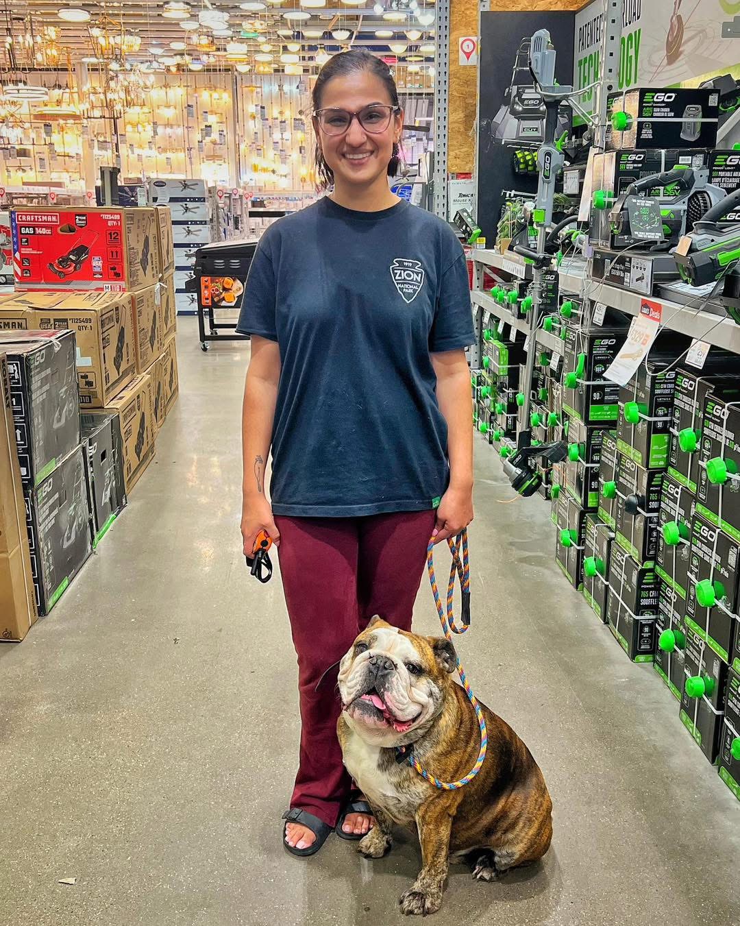 Trainer with bulldog at store